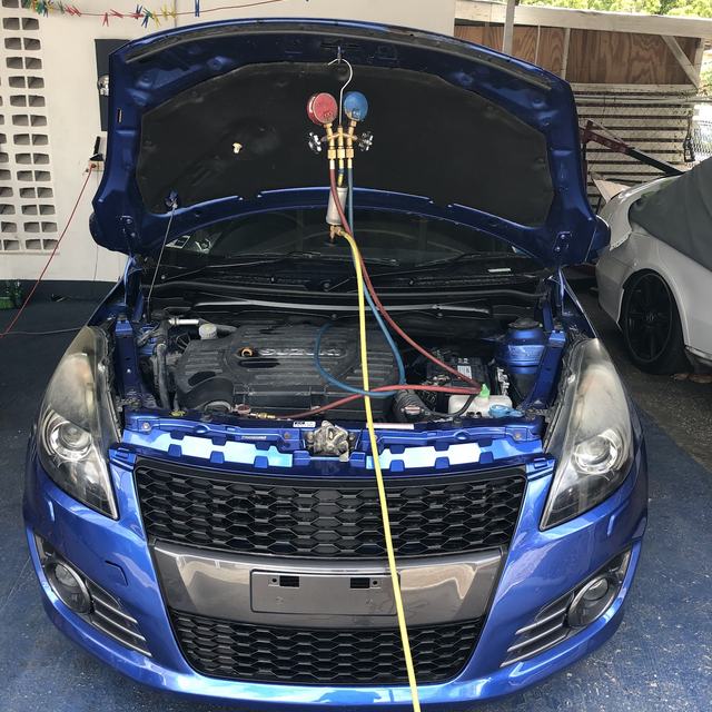 A/C gauges connected to a car under repair