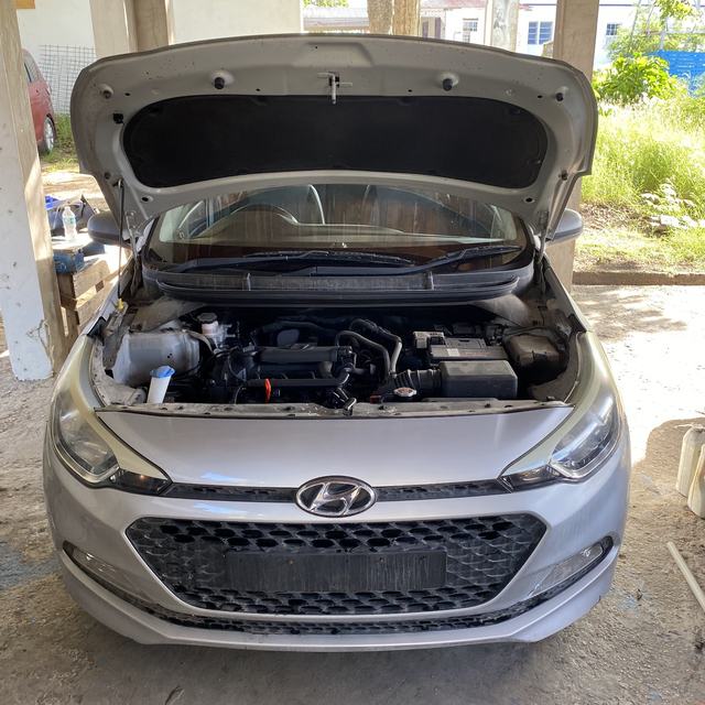 Car with bonnet open for A/C service